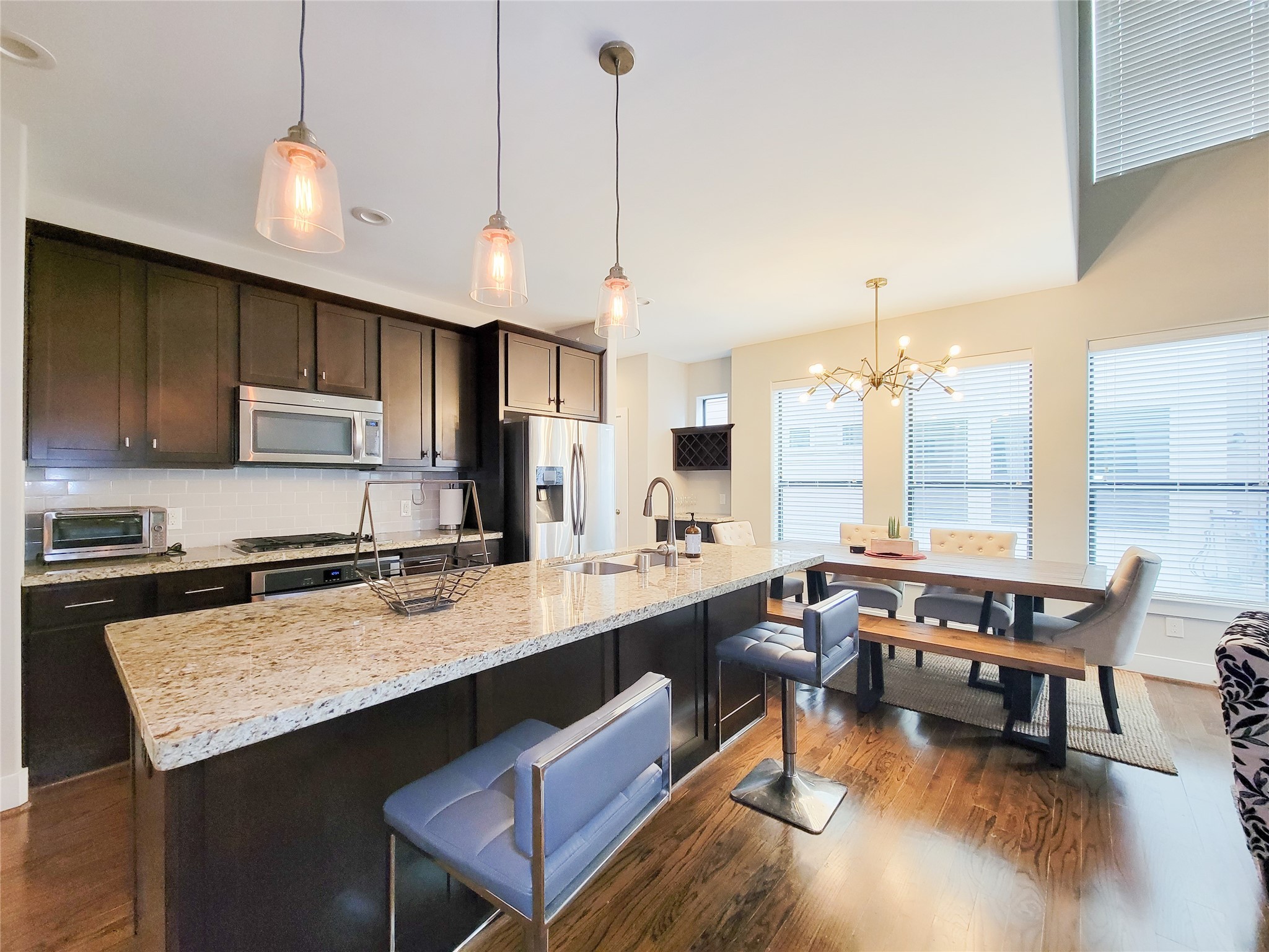 1424 Wilson Street Houston, TX 77019 - Photo 33 of 47 a large kitchen with a table chairs refrigerator and cabinets
