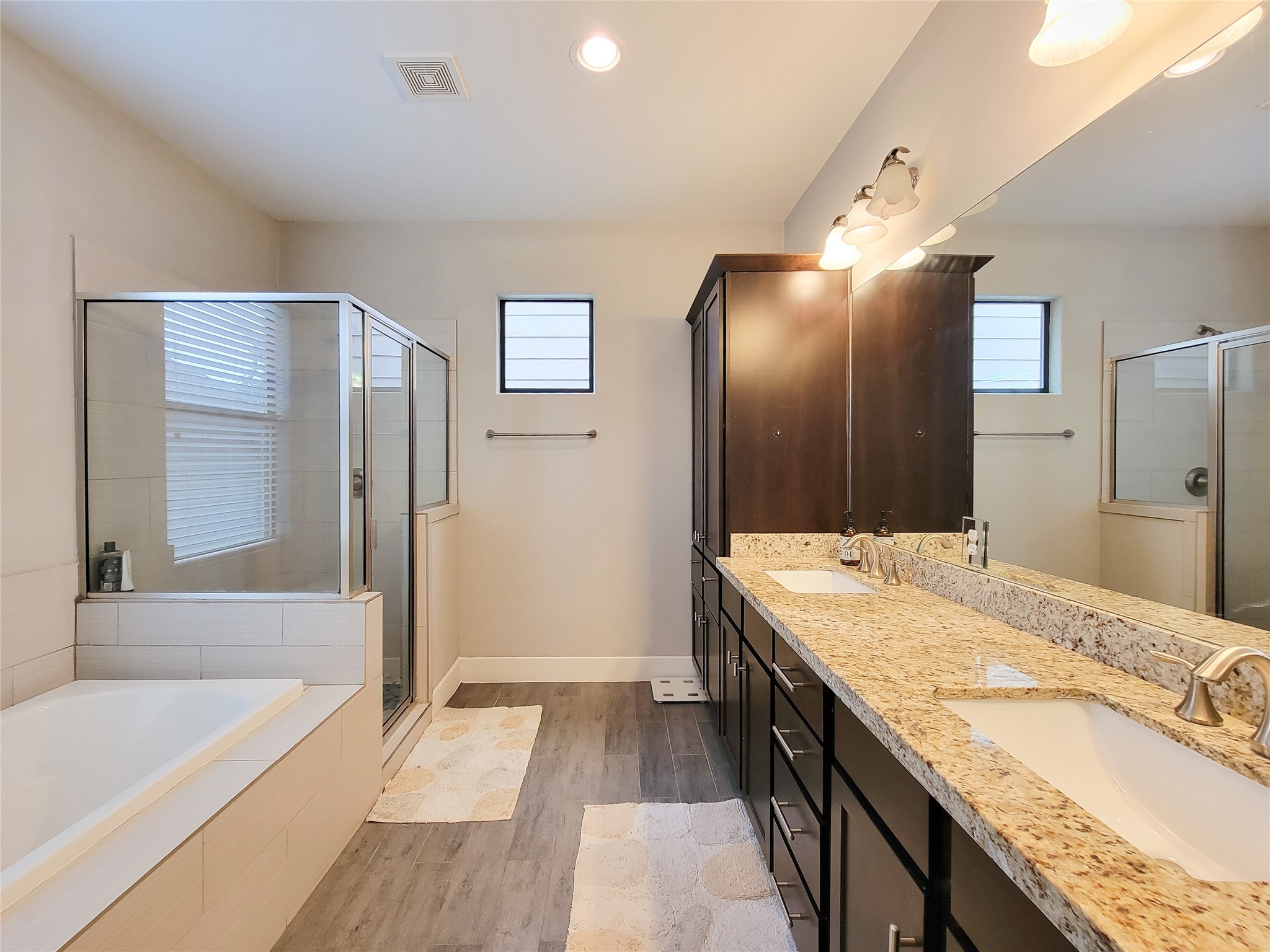 1424 Wilson Street Houston, TX 77019 - Photo 36 of 47 a spacious bathroom with a granite countertop tub sink and mirror