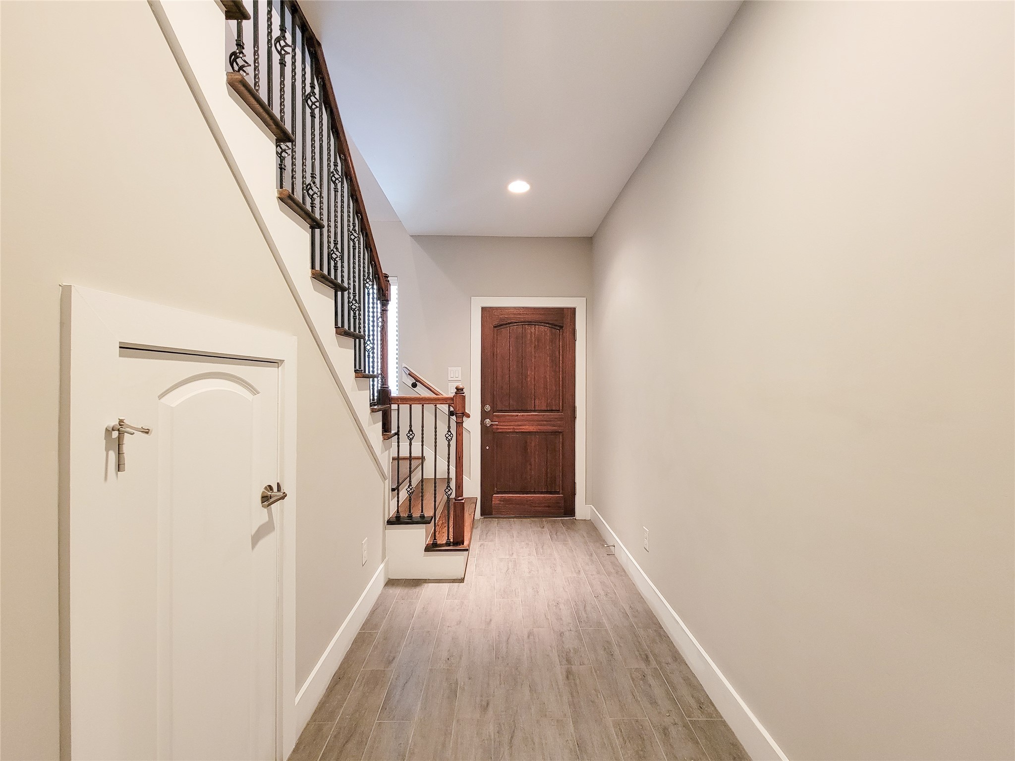 1424 Wilson Street Houston, TX 77019 - Photo 4 of 47 a view of a hallway with wooden floor and staircase