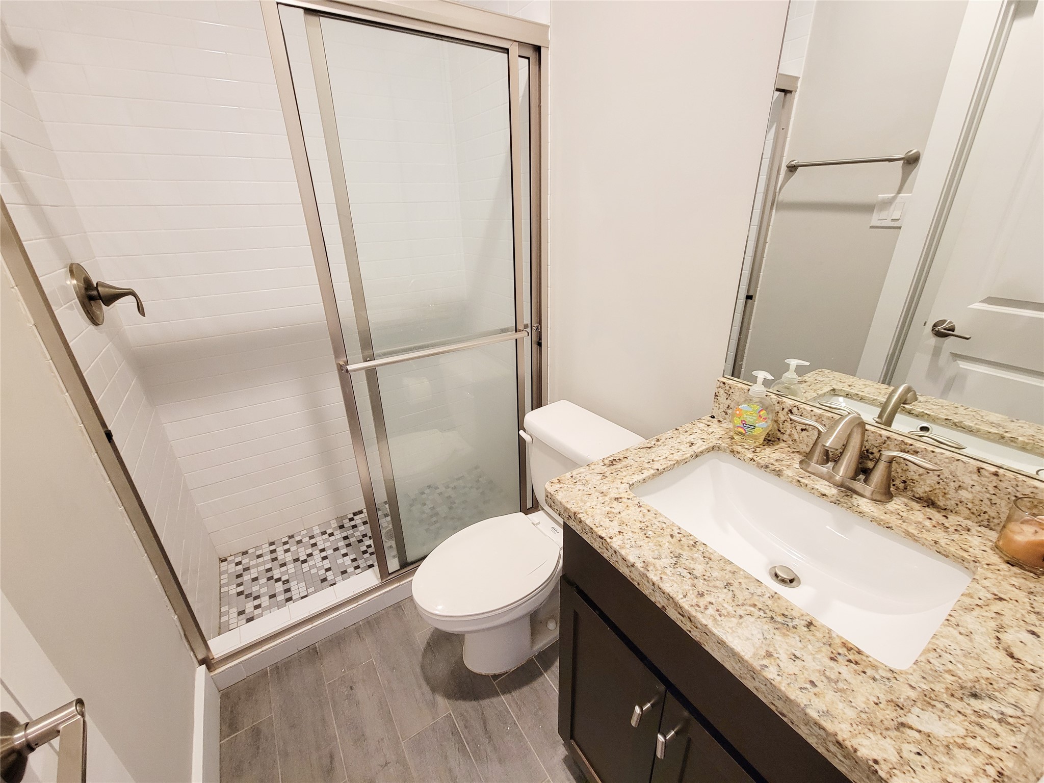 1424 Wilson Street Houston, TX 77019 - Photo 9 of 47 a bathroom with a granite countertop sink toilet and shower
