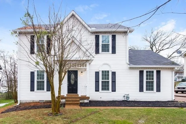 a front view of a house with yard and garage