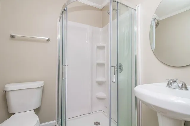 a bathroom with a toilet a sink and a mirror