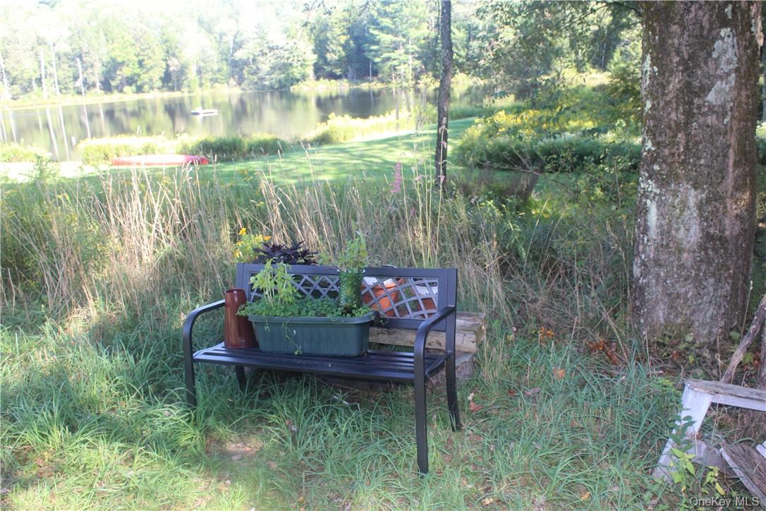 17 Gold Dan Road, Unit 56C Swan Lake, NY 12783 - Photo 25 of 33 a garden view with a sitting space