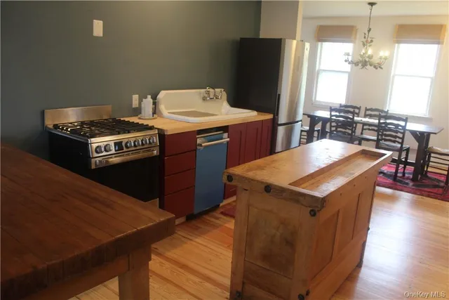 a kitchen with a stove a sink and a refrigerator