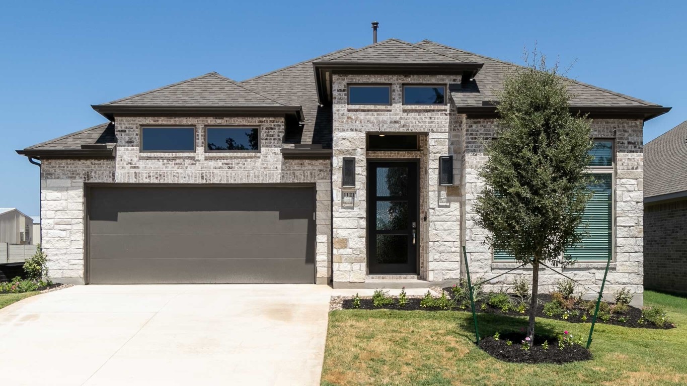 a front view of a house with a yard