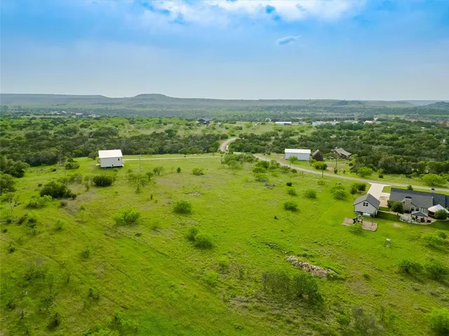 a view of a green yard with houses