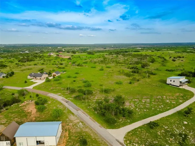 an aerial view of a house with a lake view