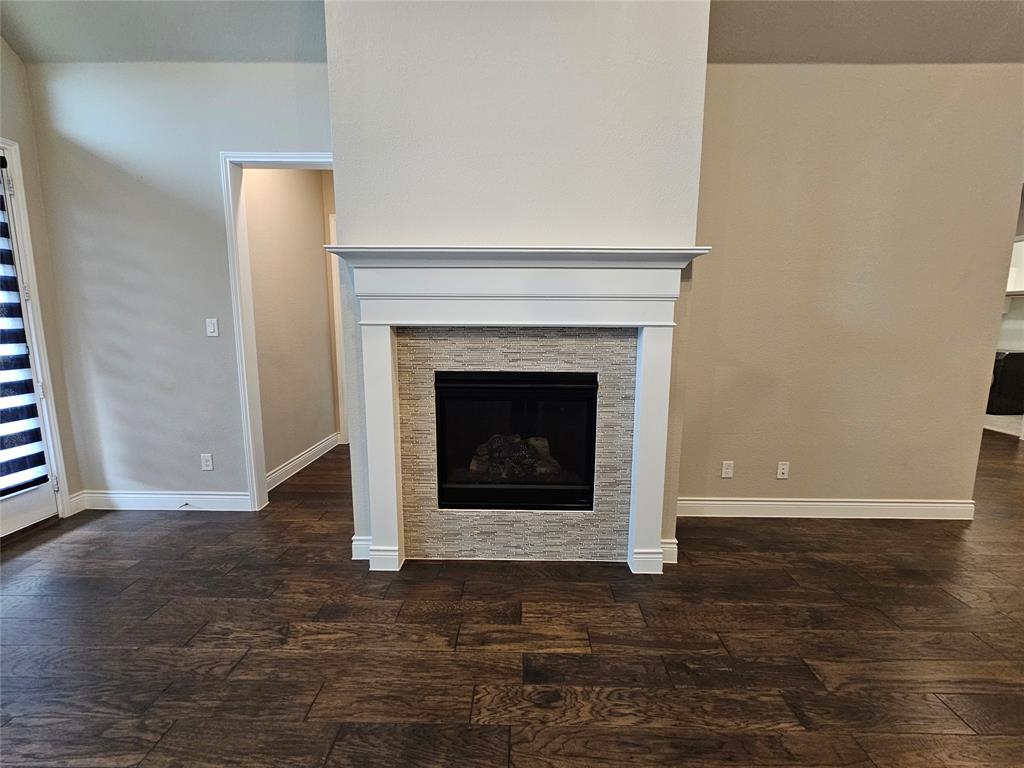 2065 Snapdragon Road Frisco, TX 75033 - Photo 11 of 39 Fireplace featuring a white mantel, stone-look tile surround, and a dark firebox