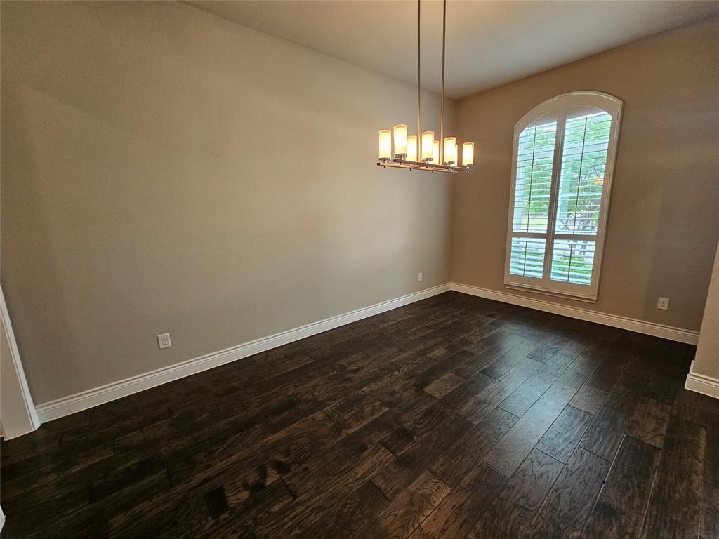 2065 Snapdragon Road Frisco, TX 75033 - Photo 19 of 39 Room featuring dark wood-finish flooring, neutral wall tones, and white baseboards