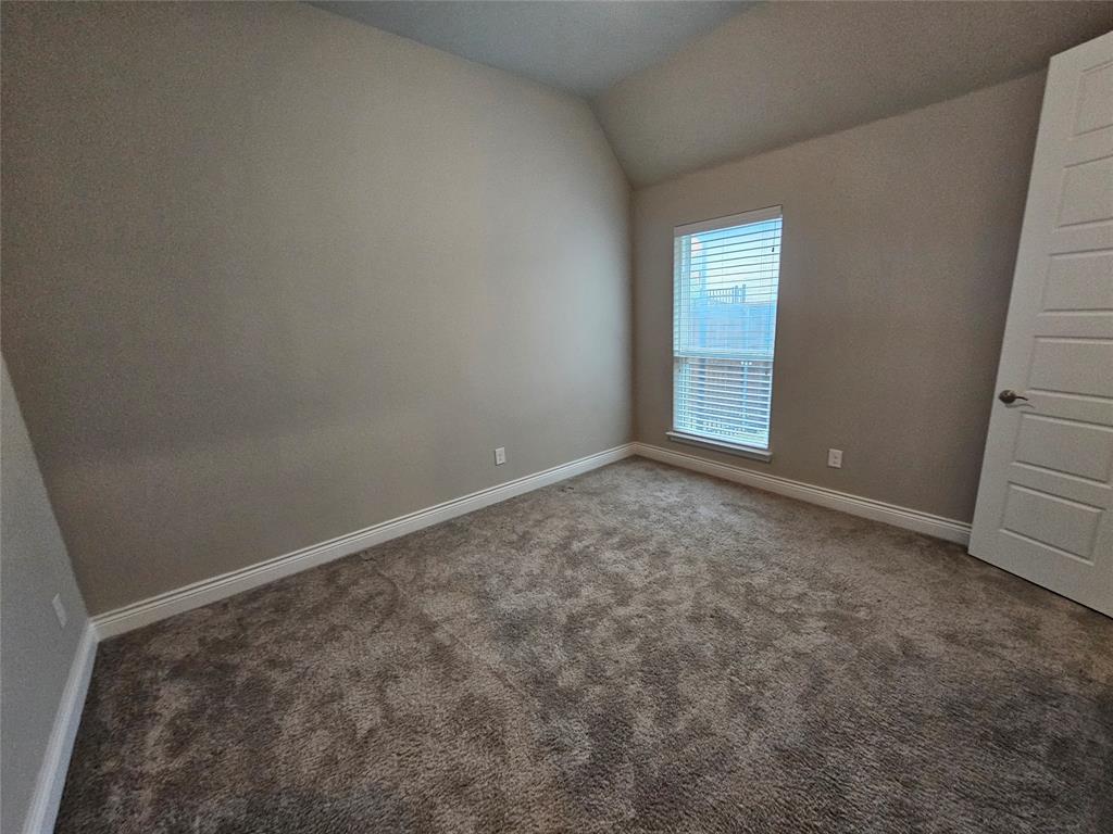 2065 Snapdragon Road Frisco, TX 75033 - Photo 24 of 39 Neutral-toned walls complement the textured gray carpet flooring