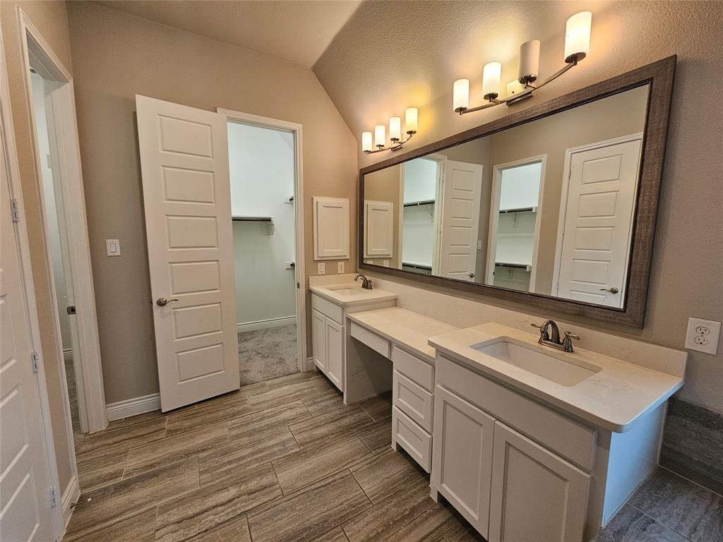 2065 Snapdragon Road Frisco, TX 75033 - Photo 30 of 39 Dual vanity bathroom featuring white cabinetry, light-toned countertops, and undermount sinks with brushed nickel fixtures