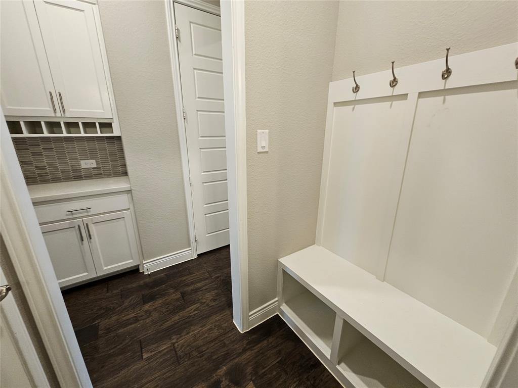 2065 Snapdragon Road Frisco, TX 75033 - Photo 34 of 39 Entryway featuring a built-in bench with storage, brushed nickel coat hooks, and dark wood-finish flooring