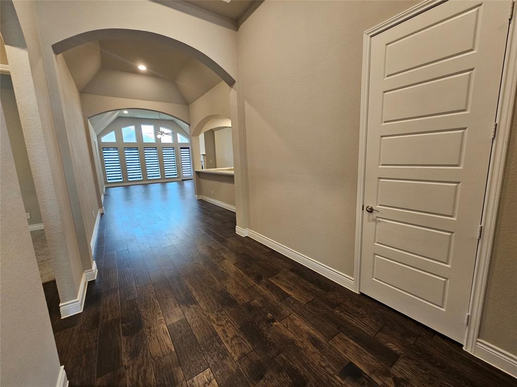 2065 Snapdragon Road Frisco, TX 75033 - Photo 36 of 39 Spacious interior entry featuring dark wood-finish flooring, arched doorways, vaulted ceilings, and extensive window treatments