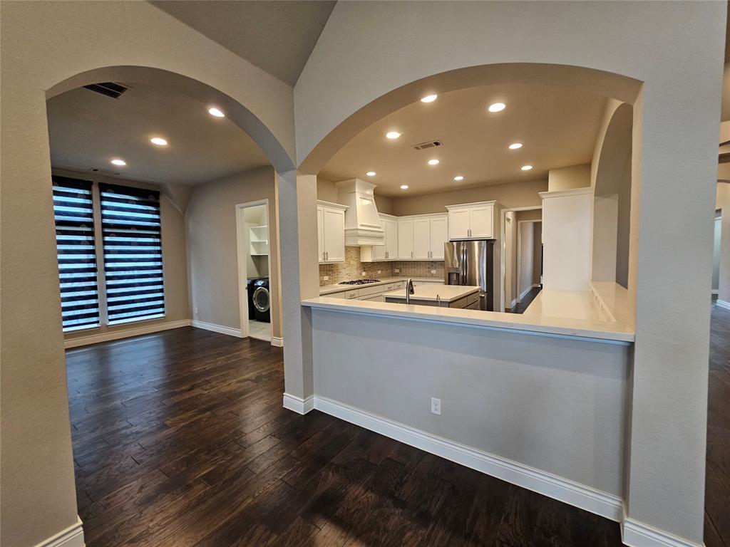 2065 Snapdragon Road Frisco, TX 75033 - Photo 8 of 39 Open-concept living space with dark wood-finish flooring