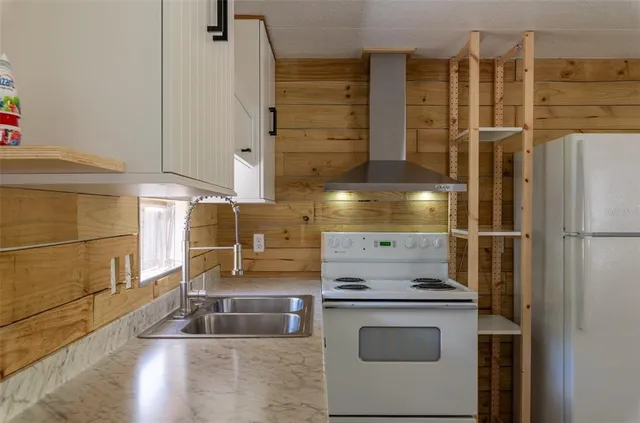 a kitchen with stainless steel appliances wooden cabinets and a sink