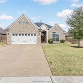 a view of house with yard and trees in front of it