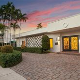 a front view of a house with garden and patio