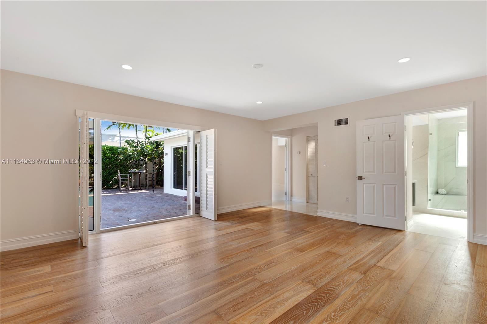 1777 Daytonia Road Miami Beach, FL 33141 - Photo 14 of 36 a view of an empty room with wooden floor and a window