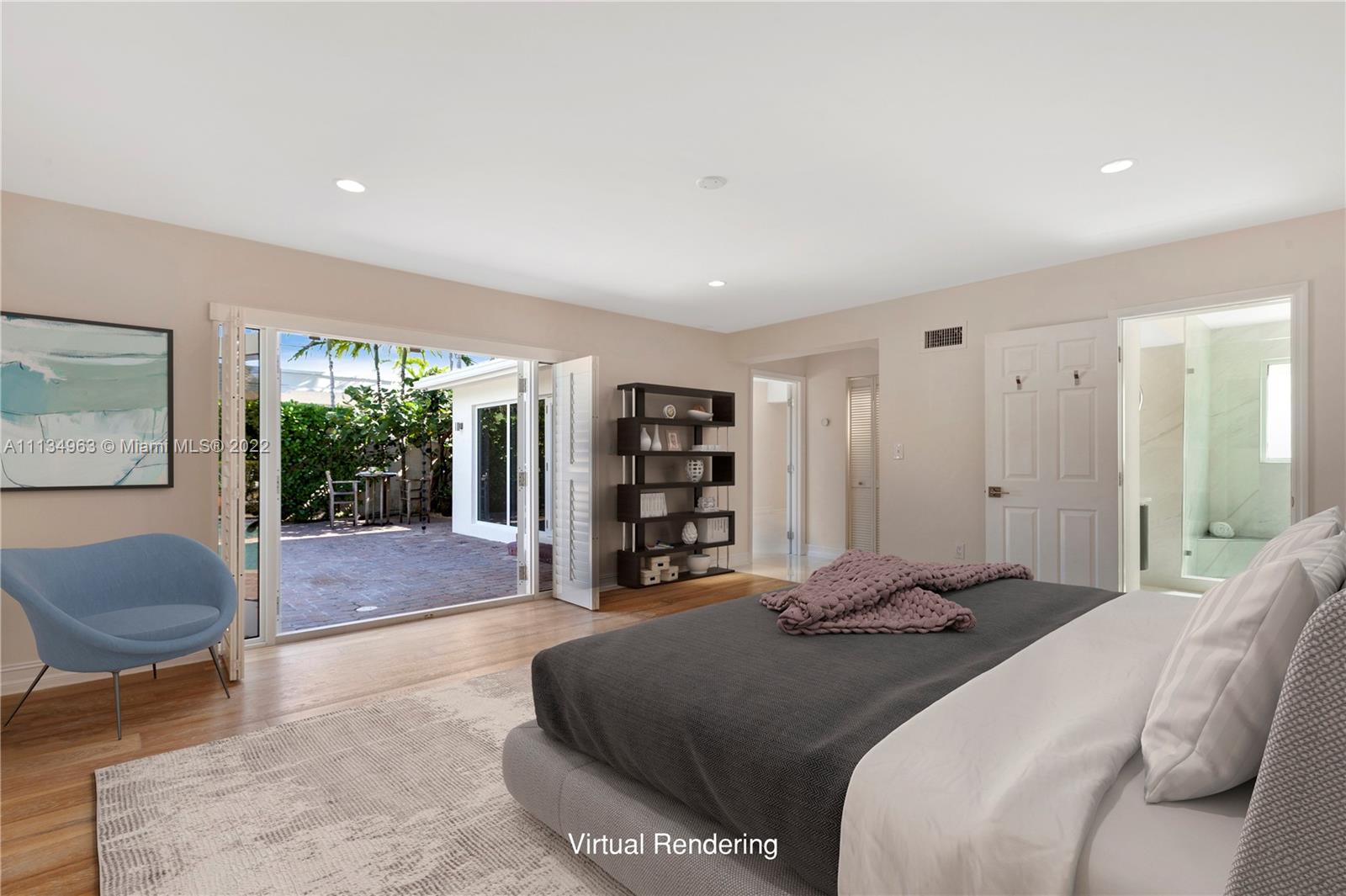 1777 Daytonia Road Miami Beach, FL 33141 - Photo 15 of 36 a spacious bedroom with a bed and a couch