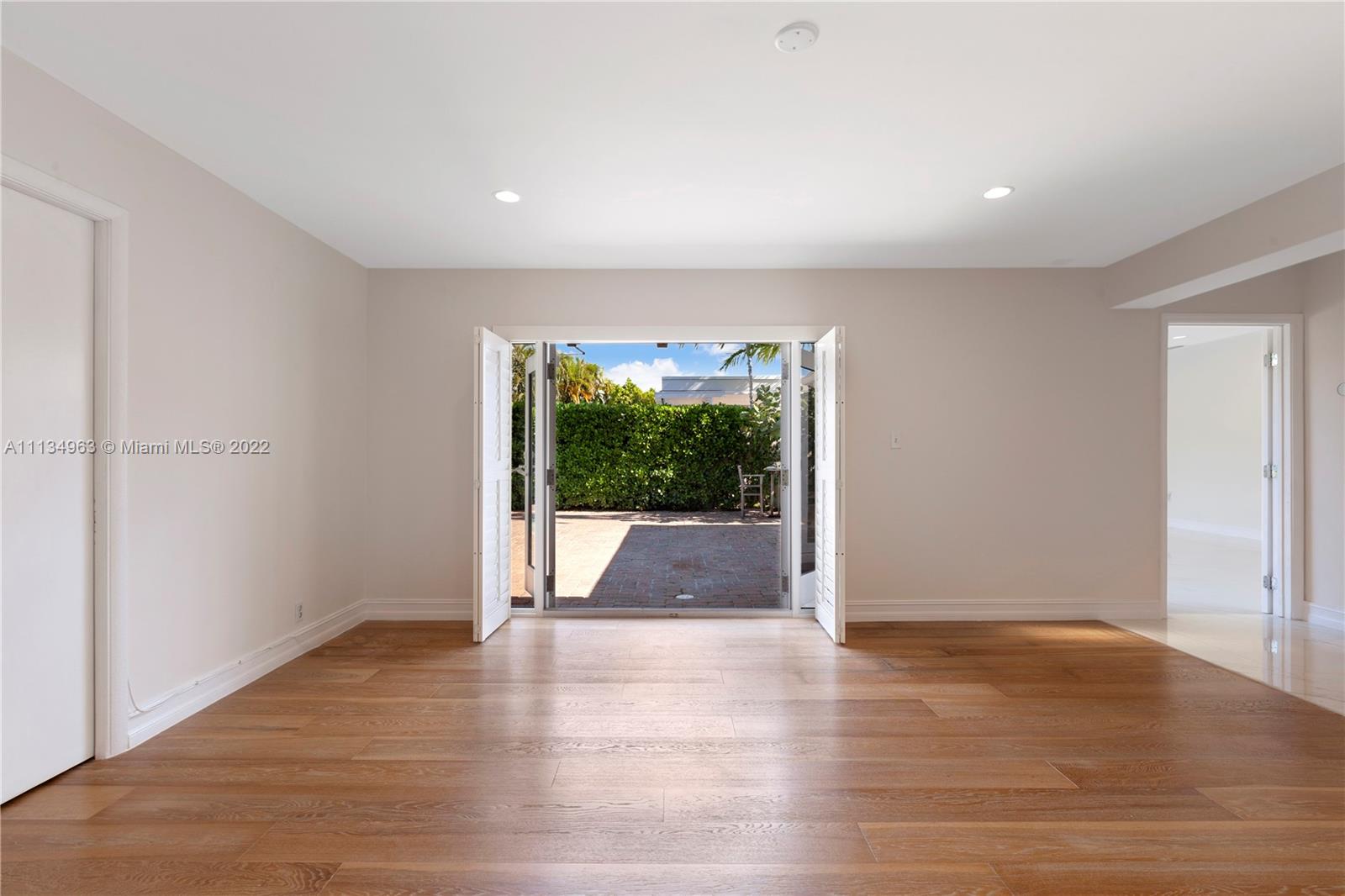 1777 Daytonia Road Miami Beach, FL 33141 - Photo 16 of 36 wooden floor in an empty room with a window