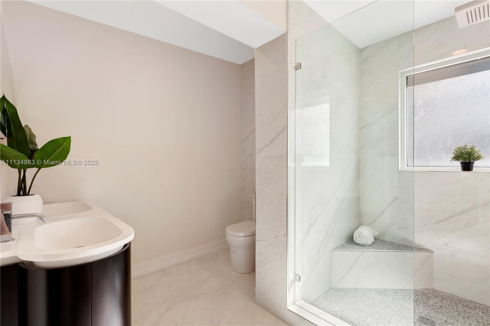 1777 Daytonia Road Miami Beach, FL 33141 - Photo 17 of 36 a bathroom with a sink and a mirror