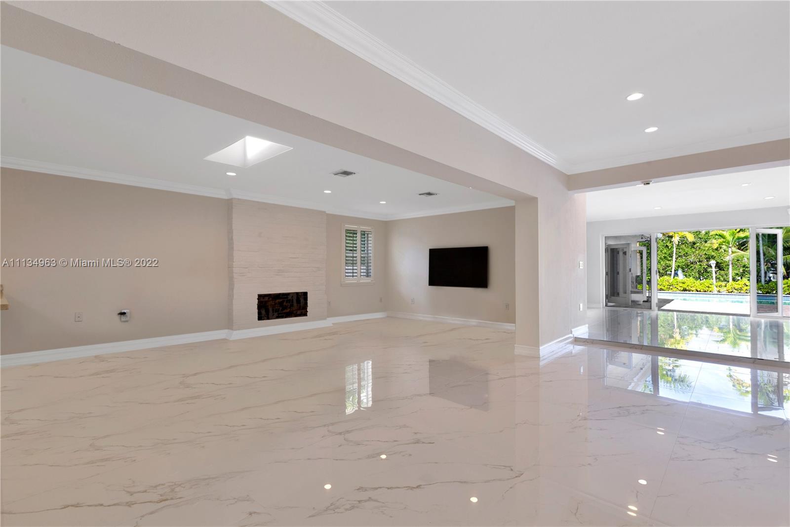 1777 Daytonia Road Miami Beach, FL 33141 - Photo 25 of 36 a view of an empty room with a fireplace and a large window