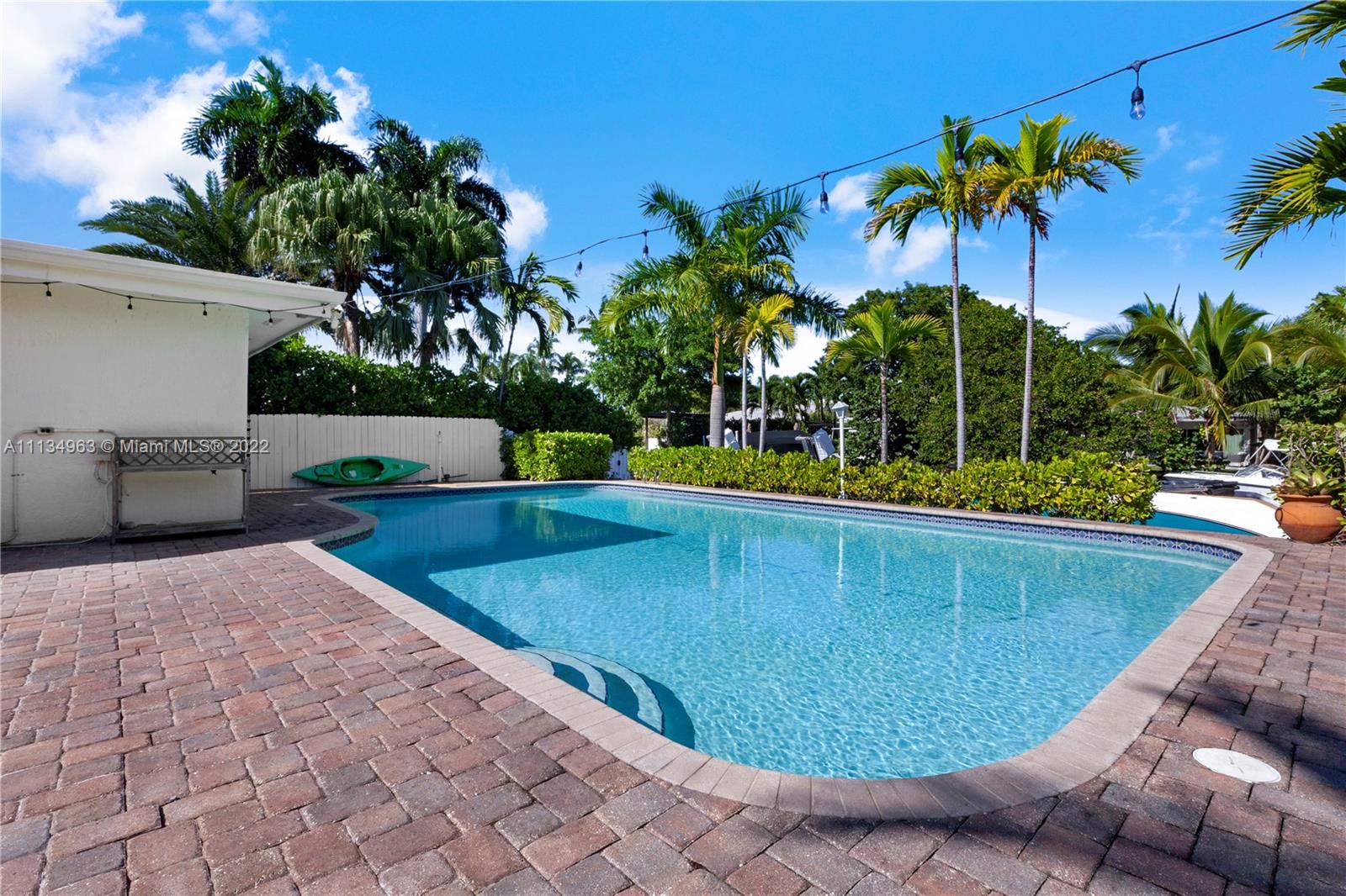 1777 Daytonia Road Miami Beach, FL 33141 - Photo 26 of 36 a view of a swimming pool with a chair and palm trees