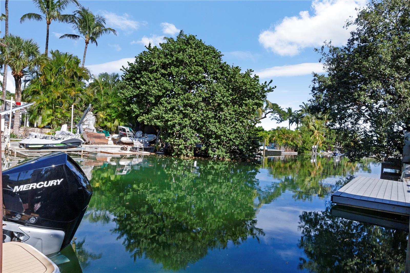 1777 Daytonia Road Miami Beach, FL 33141 - Photo 31 of 36 a wooden bench sitting next to a lake
