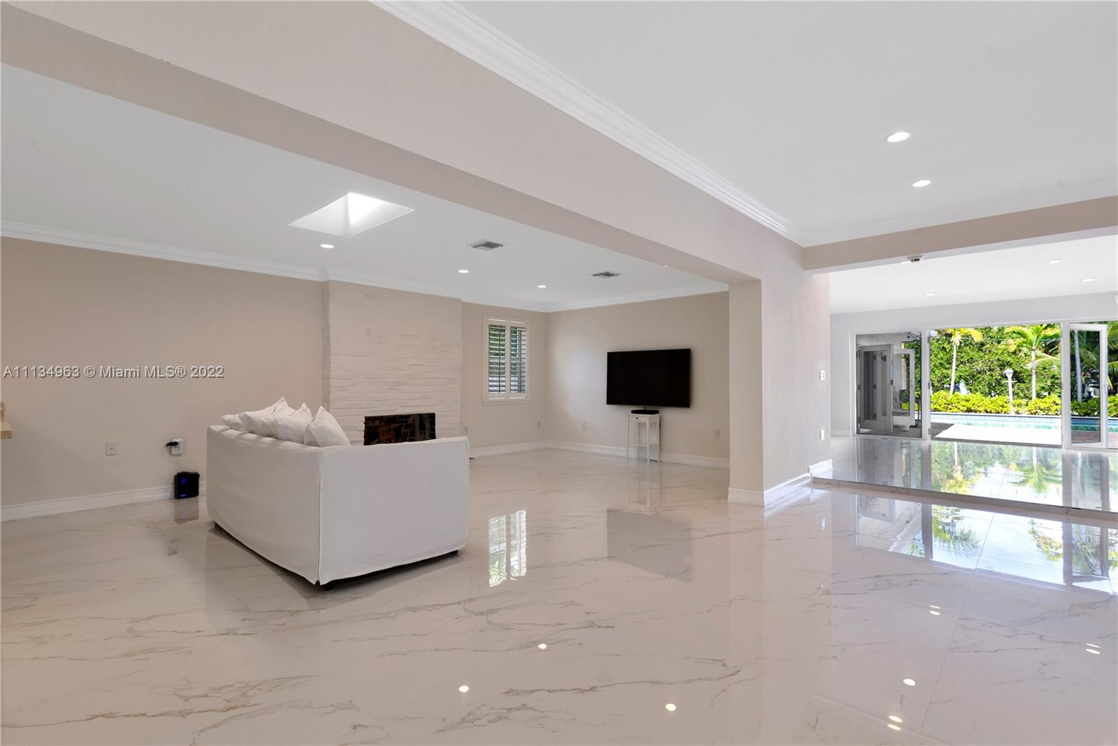1777 Daytonia Road Miami Beach, FL 33141 - Photo 7 of 36 a living room with furniture and a flat screen tv