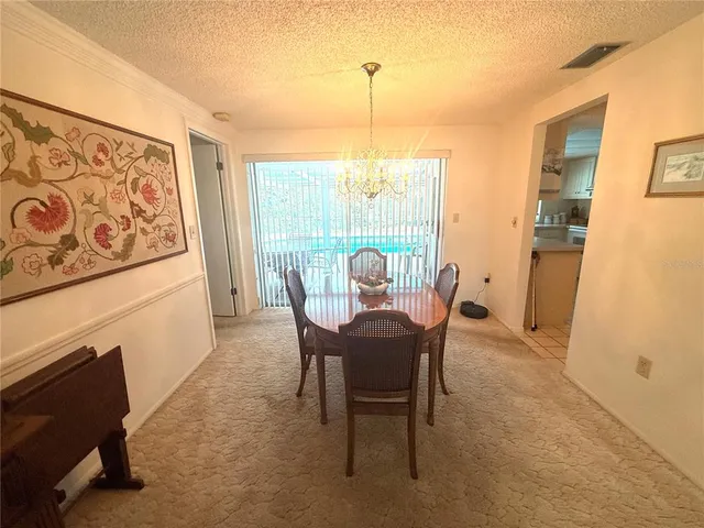 a view of a dining room with furniture and a window