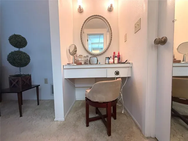 a living room with a furniture and a mirror