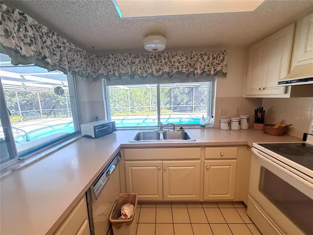 a kitchen with a sink stove and cabinets