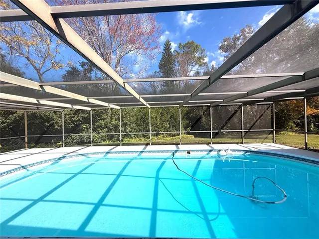 a view of a house with a large tree