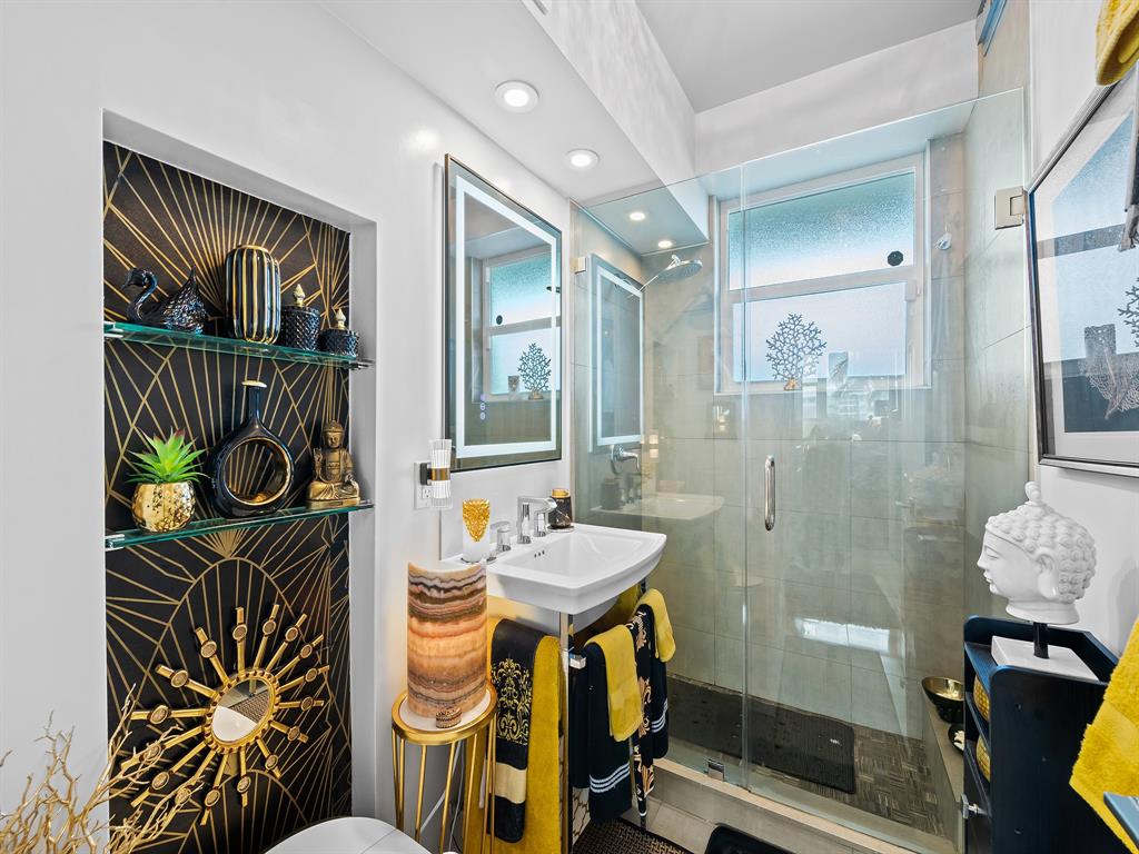 1900 South Ocean Drive, Unit 210 Fort Lauderdale, FL 33316 - Photo 15 of 31 a bathroom with a sink a mirror and a shower