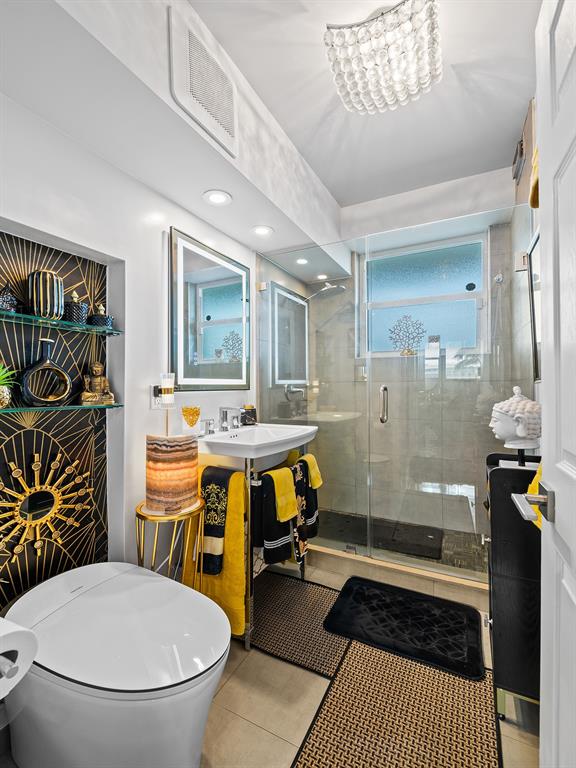 1900 South Ocean Drive, Unit 210 Fort Lauderdale, FL 33316 - Photo 16 of 31 a bathroom with a sink a toilet a mirror and shower