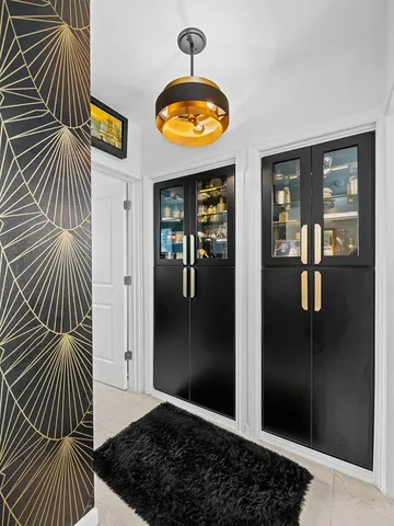 a view of a hallway with wooden floor and door