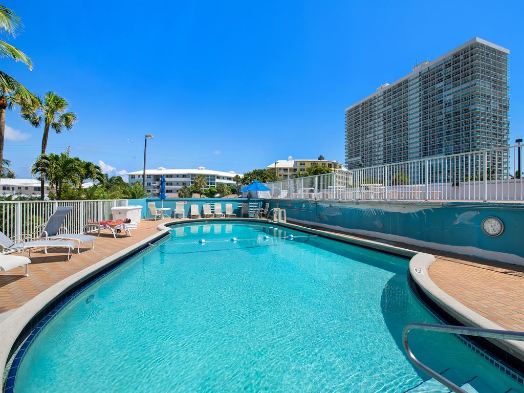1900 South Ocean Drive, Unit 210 Fort Lauderdale, FL 33316 - Photo 24 of 31 a view of a swimming pool with a lounge chair