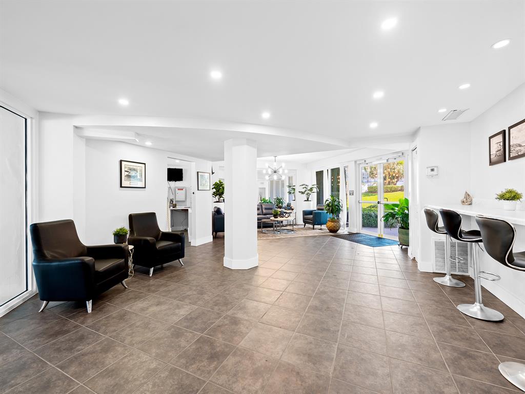 1900 South Ocean Drive, Unit 210 Fort Lauderdale, FL 33316 - Photo 27 of 31 a living room with furniture and a flat screen tv