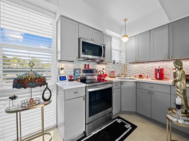 a kitchen with sink cabinets and window