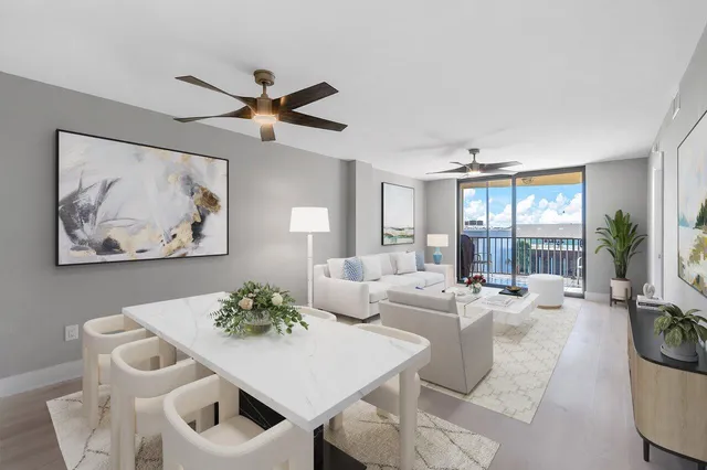 a living room with furniture a chandelier and a table