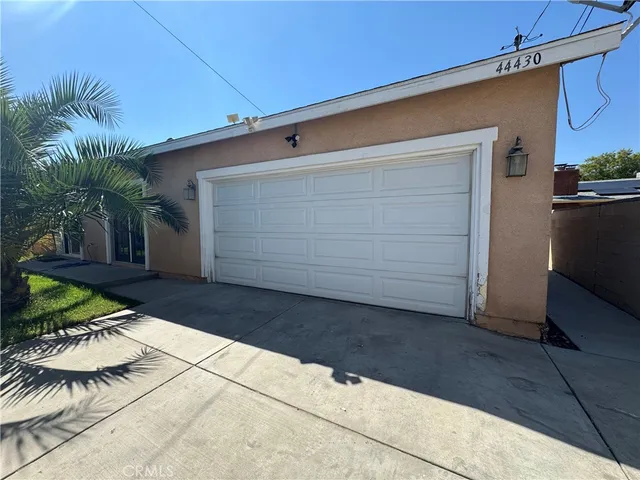a couple of potted plants in front of door