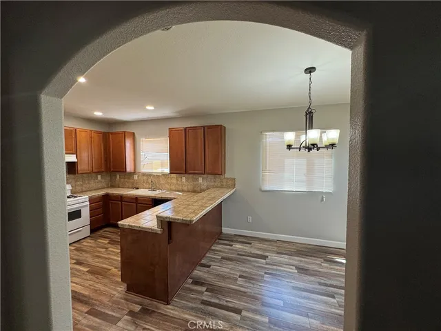 a large kitchen with kitchen island a sink stainless steel appliances and cabinets