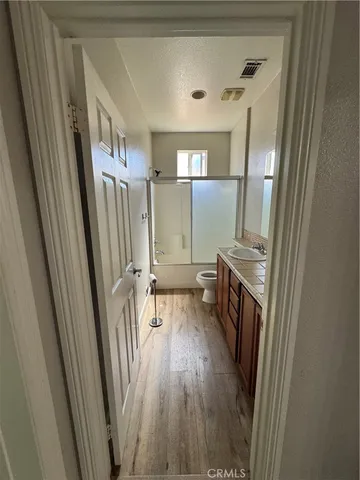 a view of a hallway and a livingroom with furniture