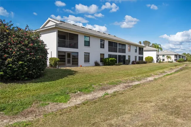 an aerial view of residential houses with yard and mountain view in back