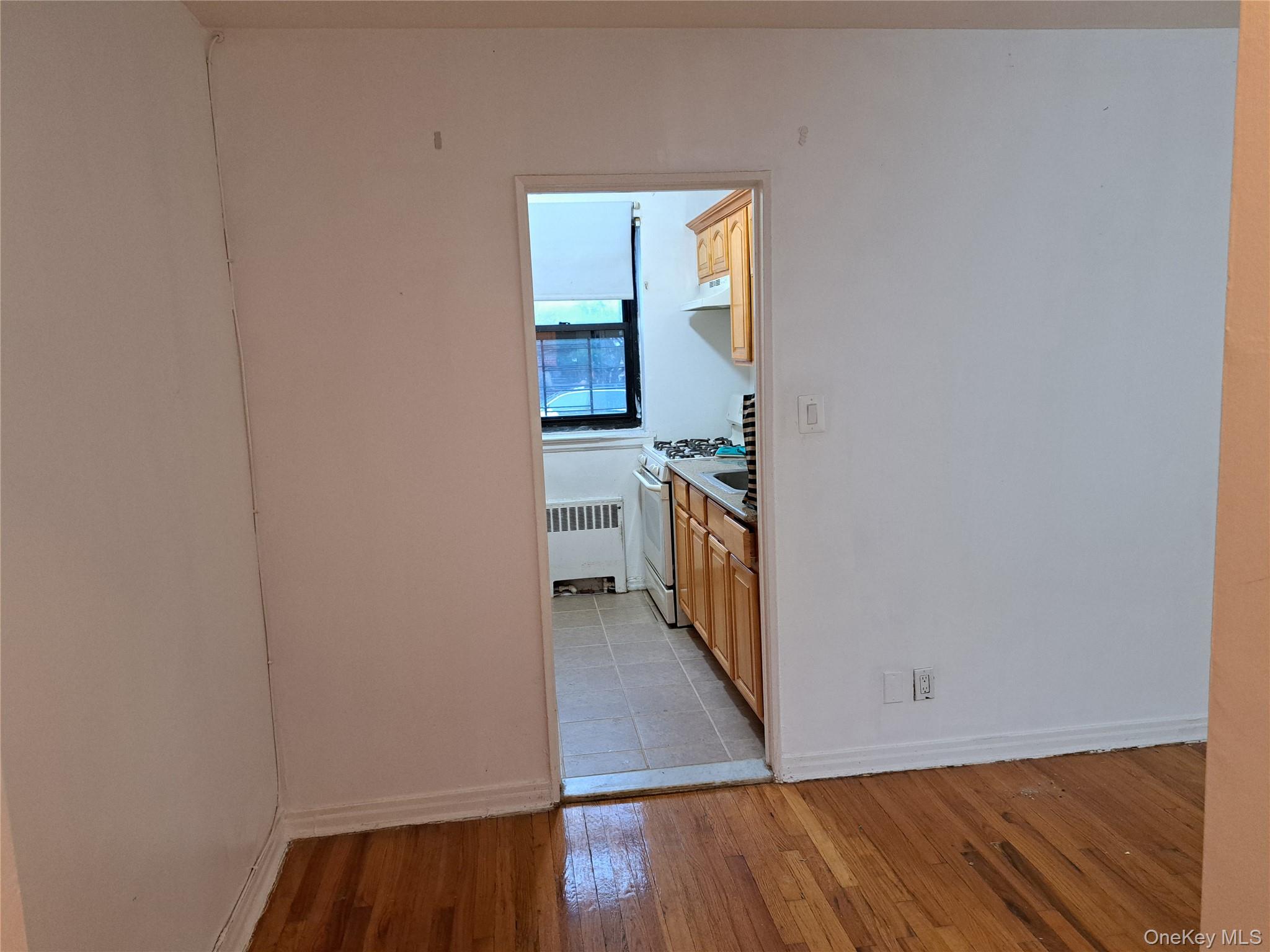 20206 Rocky Hill Road, Unit C1 Queens, NY 11361 - Photo 4 of 17 a view of a hallway with wooden floor and a bathroom