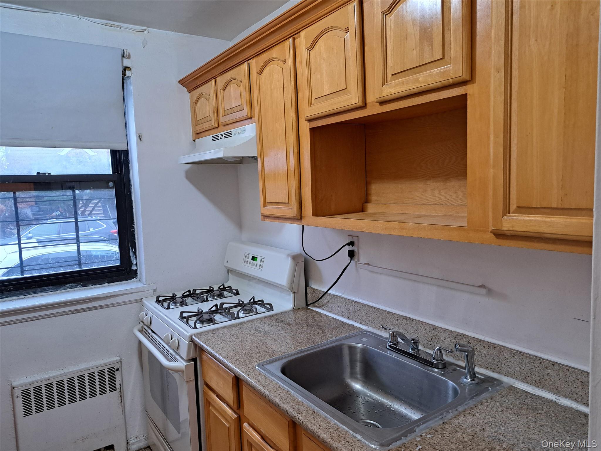 20206 Rocky Hill Road, Unit C1 Queens, NY 11361 - Photo 10 of 17 a kitchen with stainless steel appliances granite countertop a sink stove and cabinets