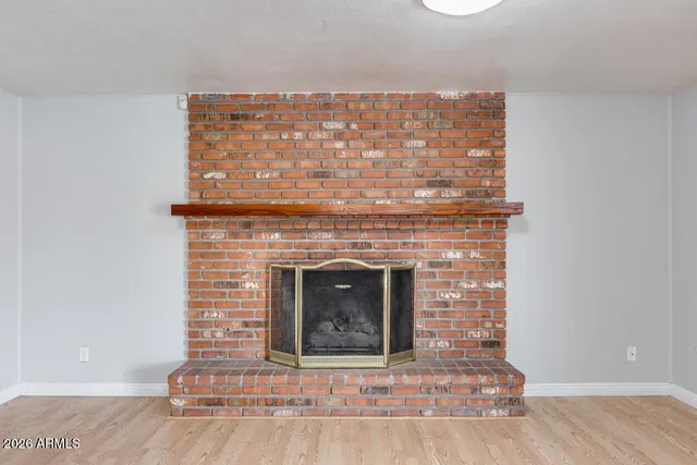 a view of fireplace and wooden floor