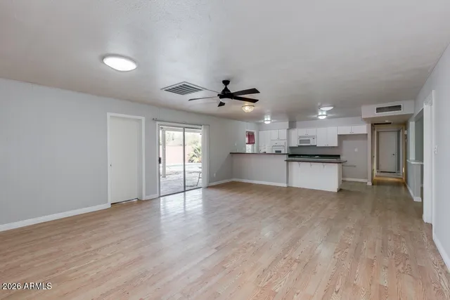 a view of kitchen with wooden floor and windows