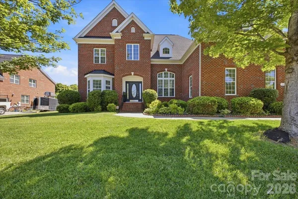 a front view of a house with a yard