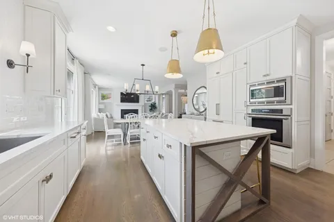 a large kitchen with a lot of counter space and a wooden floor